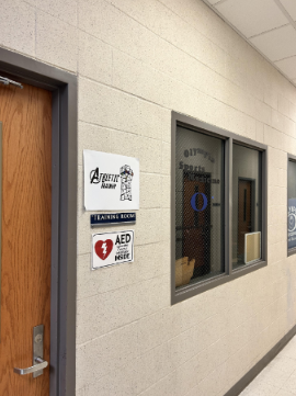 The athletic trainer's office is located in the hall between the main and auxiliary gyms.  
