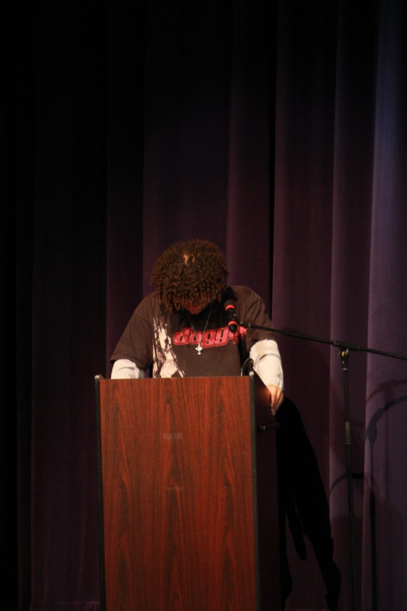 Sophomore Jordy Mendez delivers a speech about his experience growing up in a white household at the MLK assembly.