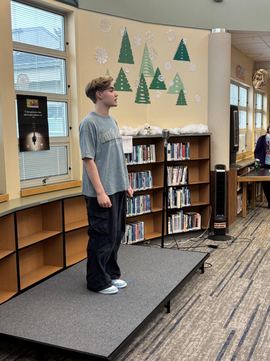 Photo shows Max Ehret reciting “Siblings” by Patricia Smith, the poem that won him the competition.