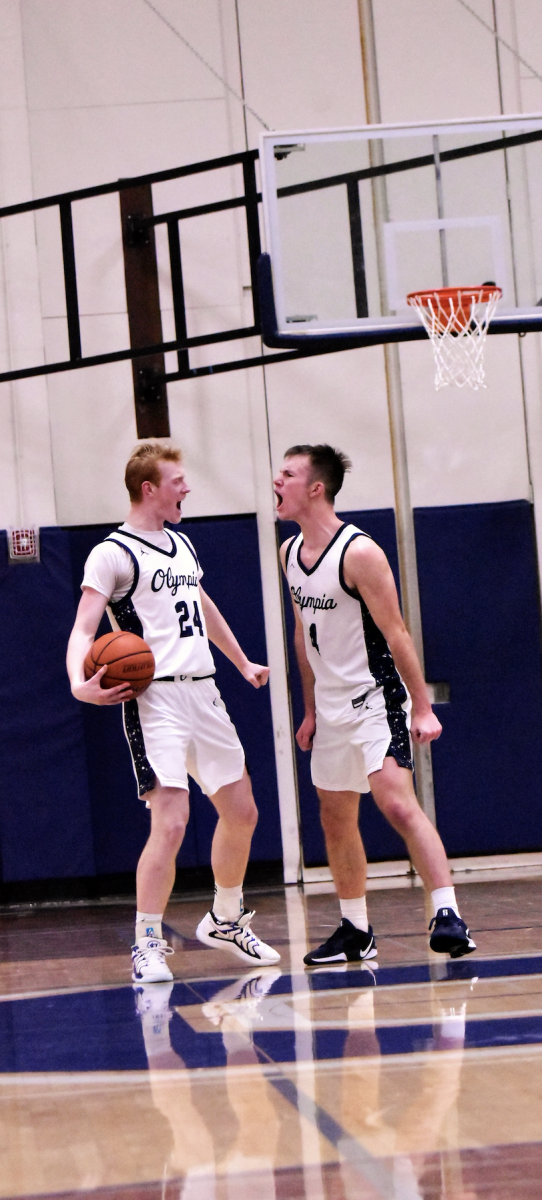 Senior Matt Linblom and senior Blake Peterson celebrate the win as the crowd electrifies Creighton Court