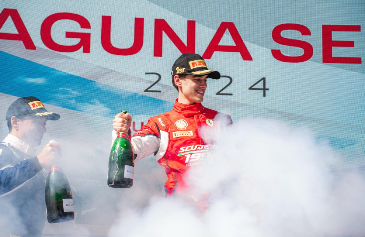 Massimo Perrina celebrating on the podium after a race. Photo courtesy of Olga Heilagr